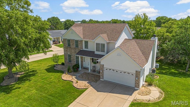 2 Meramec Shores Ct, Ofallon, MO 63366 - traditional home with stone siding, concrete driveway, a garage, a front lawn, and a chimney
