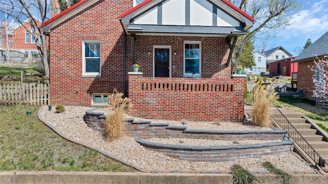 125 W 2nd St, Hermann, MO 65041 - tudor house featuring brick siding and fence
