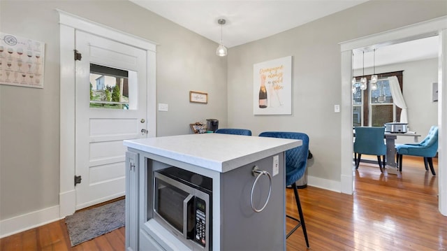 125 W 2nd St, Hermann, MO 65041 - dining room featuring dark wood-type flooring and baseboards