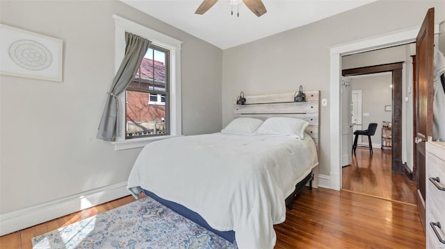 125 W 2nd St, Hermann, MO 65041 - bedroom with wood finished floors, baseboards, and ceiling fan