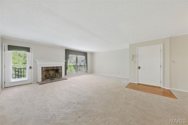 2037 Trailcrest Ln Unit 7, Saint Louis, MO 63122 - unfurnished living room with carpet flooring, a textured ceiling, a brick fireplace, and baseboards