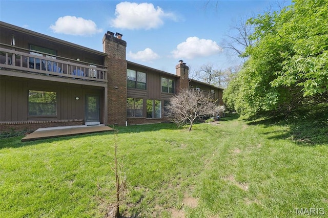 2037 Trailcrest Ln Unit 7, Saint Louis, MO 63122 - rear view of house featuring a chimney, a lawn, and brick siding