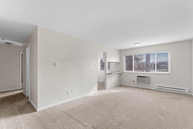 unfurnished living room with baseboard heating, carpet, a wall mounted AC, and baseboards