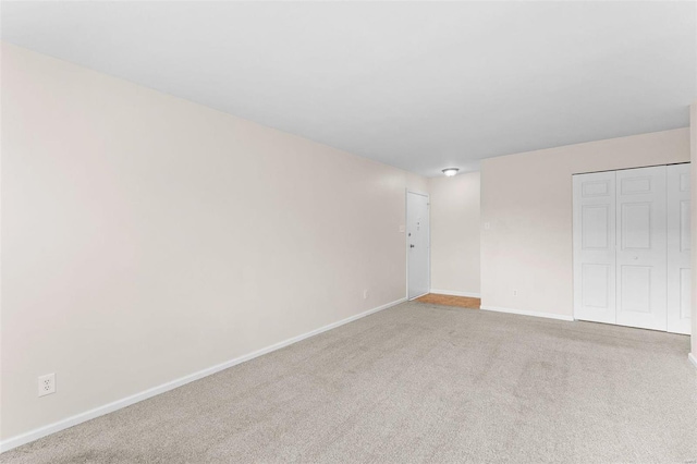 unfurnished room featuring baseboards and carpet floors