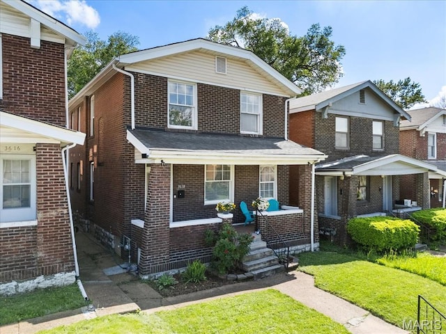 3618 Mcree Ave, Saint Louis, MO 63110 - view of front of home with a porch, a front lawn, and brick siding