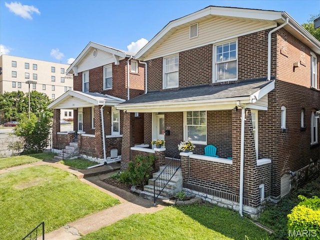 3618 Mcree Ave, Saint Louis, MO 63110 - view of front of home with covered porch, a front yard, and brick siding