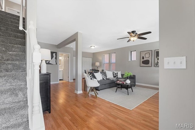 3618 Mcree Ave, Saint Louis, MO 63110 - living area featuring stairway, light wood-style floors, ceiling fan, and baseboards