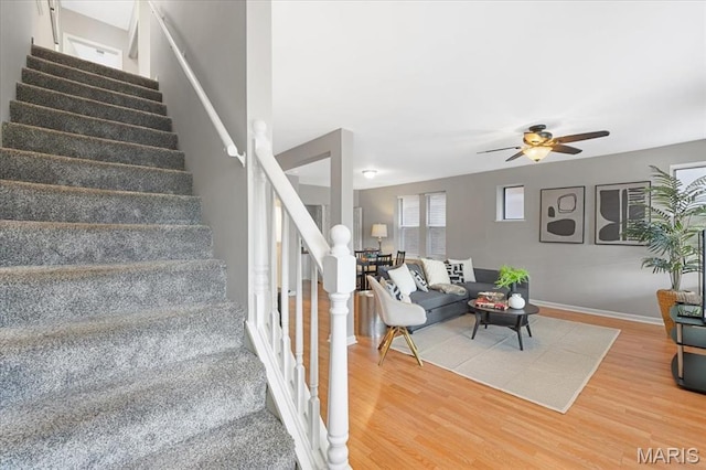 3618 Mcree Ave, Saint Louis, MO 63110 - stairs with wood finished floors, a ceiling fan, and baseboards