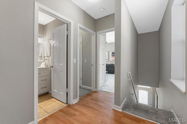 3618 Mcree Ave, Saint Louis, MO 63110 - hallway featuring an upstairs landing, light wood finished floors, and baseboards