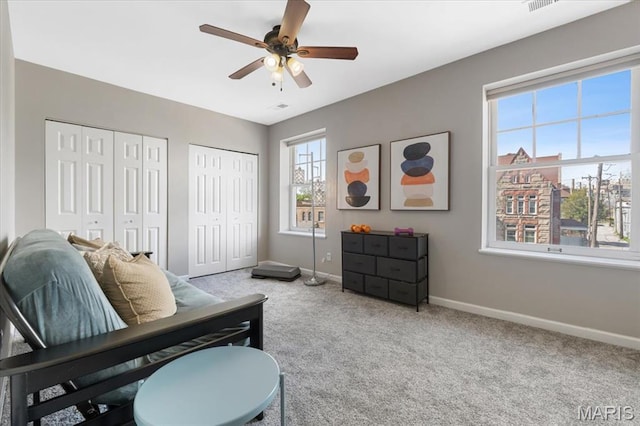 3618 Mcree Ave, Saint Louis, MO 63110 - bedroom featuring baseboards, multiple closets, carpet flooring, and a ceiling fan