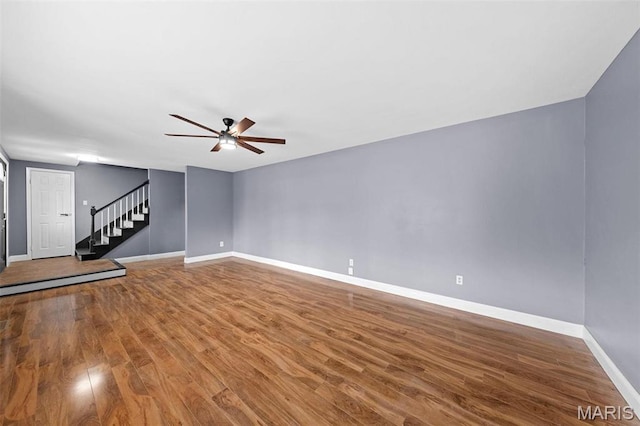 2915 Coram Dr, Saint Louis, MO 63129 - unfurnished living room with a ceiling fan, baseboards, wood finished floors, and stairs