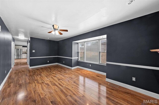 2915 Coram Dr, Saint Louis, MO 63129 - spare room featuring a ceiling fan, wood finished floors, and baseboards