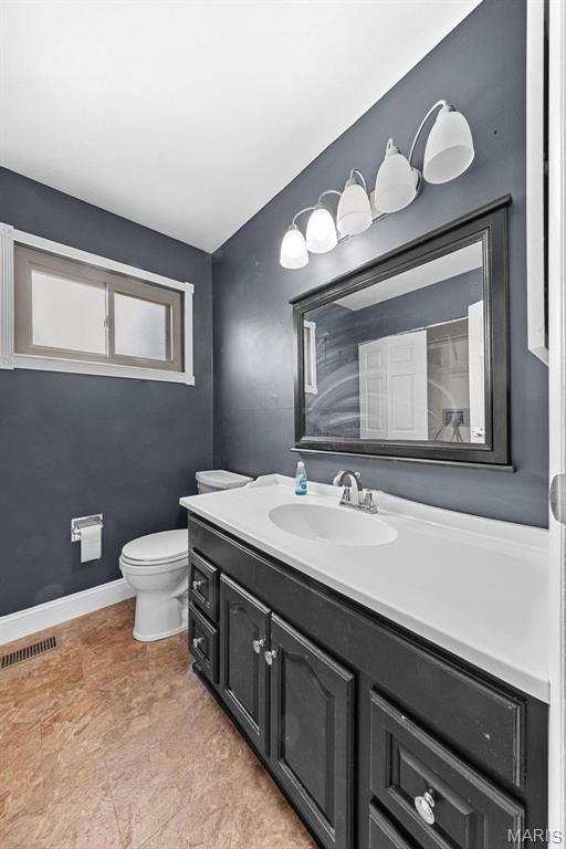 2915 Coram Dr, Saint Louis, MO 63129 - bathroom with vanity, toilet, and baseboards