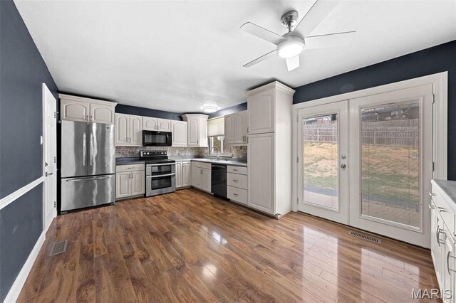 2915 Coram Dr, Saint Louis, MO 63129 - kitchen featuring black appliances, dark wood finished floors, tasteful backsplash, french doors, and ceiling fan