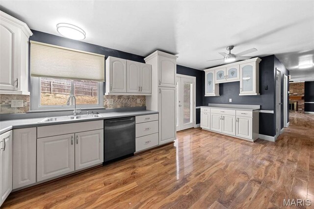 2915 Coram Dr, Saint Louis, MO 63129 - kitchen featuring dishwasher, a sink, ceiling fan, and decorative backsplash