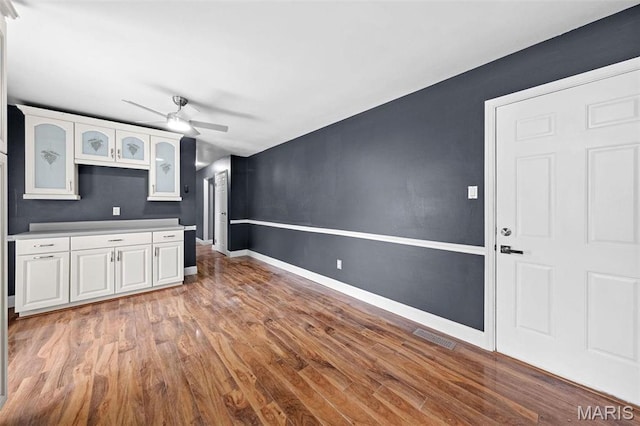 2915 Coram Dr, Saint Louis, MO 63129 - unfurnished living room featuring a ceiling fan, light wood-style floors, and baseboards