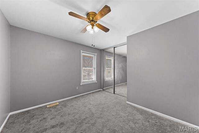 2915 Coram Dr, Saint Louis, MO 63129 - unfurnished bedroom with carpet, baseboards, a closet, and ceiling fan