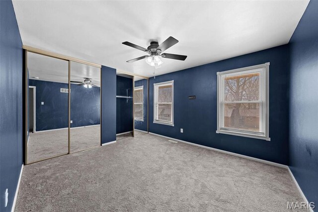 2915 Coram Dr, Saint Louis, MO 63129 - unfurnished bedroom featuring carpet, baseboards, a ceiling fan, and two closets
