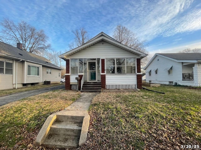 145 S 34th St, Belleville, IL 62226 - view of front of home with brick siding, a front yard, and central AC unit