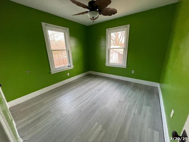145 S 34th St, Belleville, IL 62226 - empty room featuring healthy amount of natural light, wood finished floors, baseboards, and ceiling fan