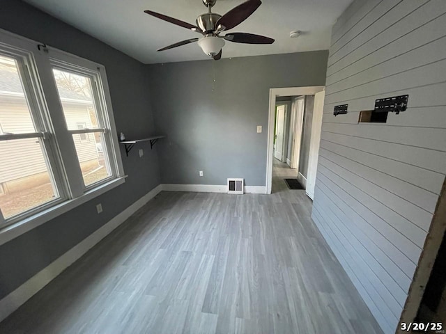 145 S 34th St, Belleville, IL 62226 - unfurnished room with wood walls, wood finished floors, baseboards, a ceiling fan, and a smoke detector