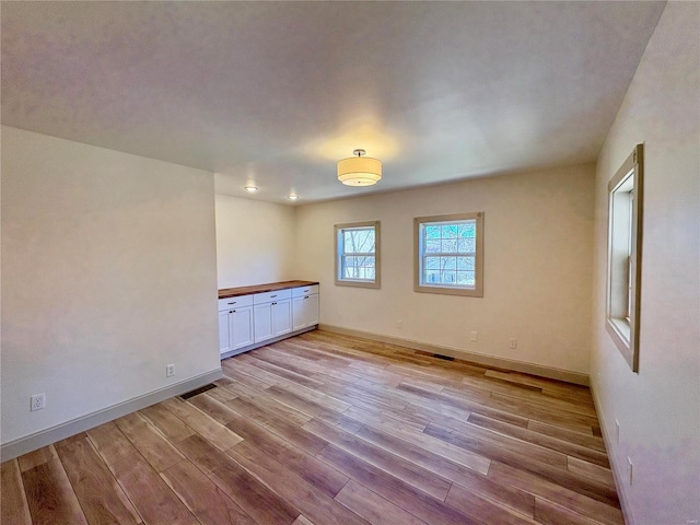 107 S Jackson St, Perryville, MO 63775 - spare room featuring light wood-style floors and baseboards