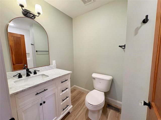 107 S Jackson St, Perryville, MO 63775 - bathroom with toilet, baseboards, wood finished floors, and vanity