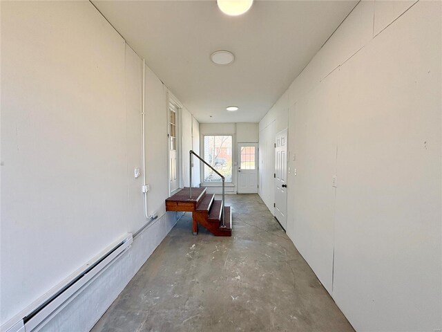 107 S Jackson St, Perryville, MO 63775 - hallway featuring a baseboard heating unit and unfinished concrete floors