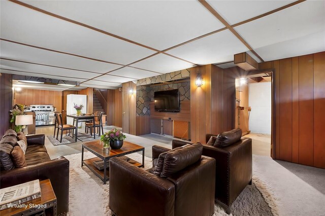 1163 Peace Valley Ln, Hermann, MO 65041 - living area featuring stairway, wood walls, and light carpet