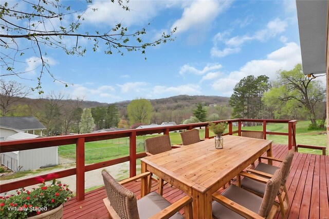1163 Peace Valley Ln, Hermann, MO 65041 - wooden deck with outdoor dining space and a lawn