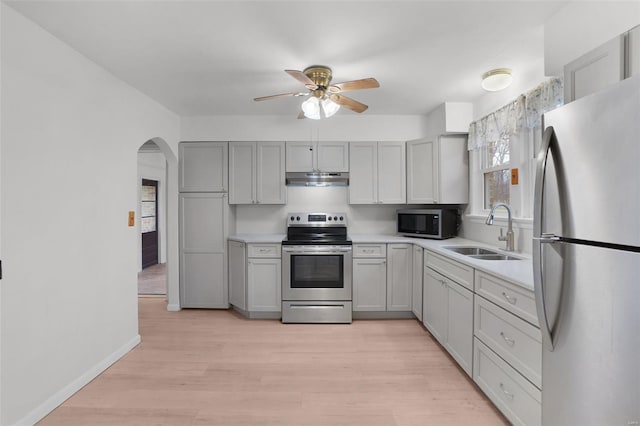 1163 Peace Valley Ln, Hermann, MO 65041 - kitchen featuring stainless steel appliances, a sink, ceiling fan, light countertops, and under cabinet range hood