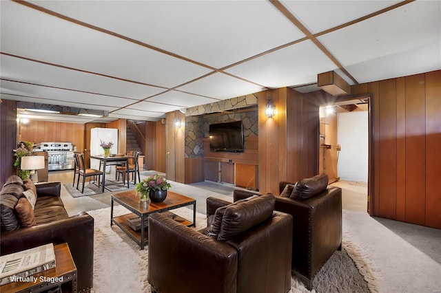 1163 Peace Valley Ln, Hermann, MO 65041 - living room with stairway, wood walls, and light carpet