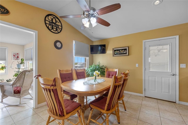 dining room featuring lofted ceiling, ceiling fan, light tile patterned floors, and baseboards