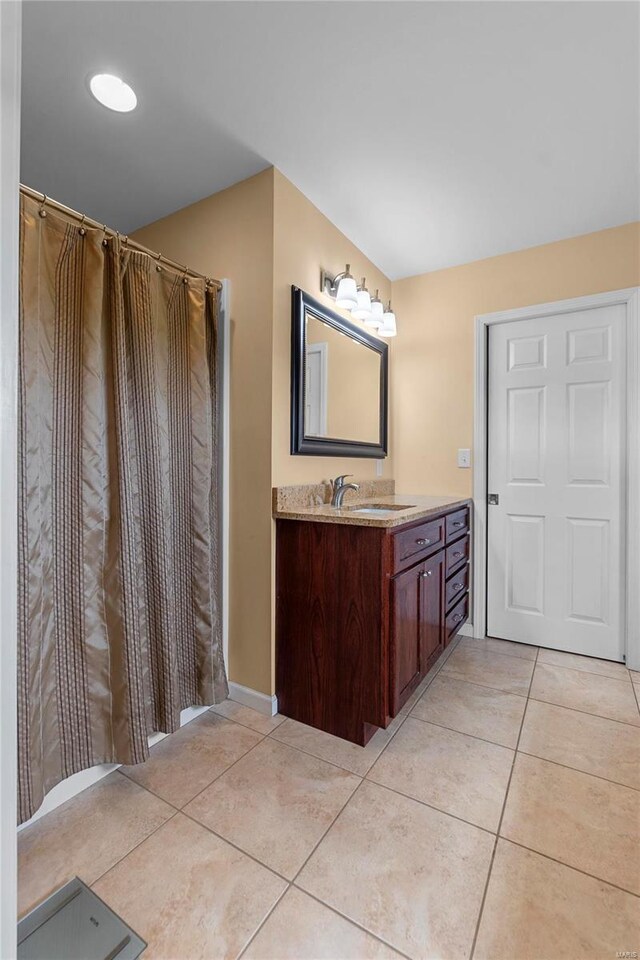 bathroom with tile patterned floors and vanity