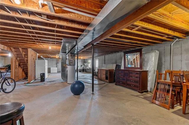 below grade area with gas water heater, stairs, heating unit, and freestanding refrigerator