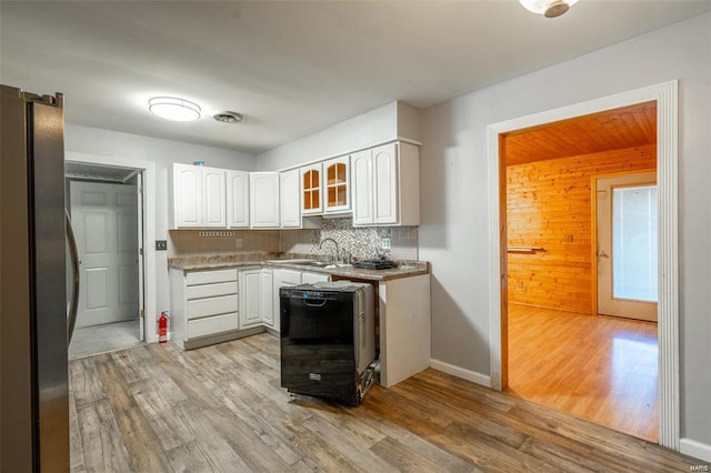 13 Wayne 357b, Piedmont, MO 63957 - kitchen featuring freestanding refrigerator, white cabinets, light wood finished floors, a sink, and wooden walls