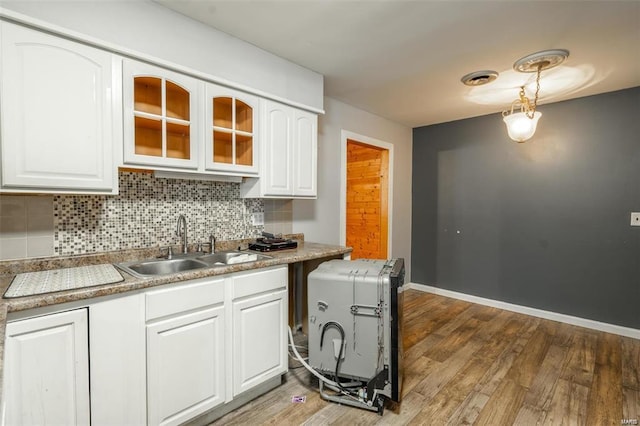 13 Wayne 357b, Piedmont, MO 63957 - kitchen featuring a sink, backsplash, light wood finished floors, and white cabinets