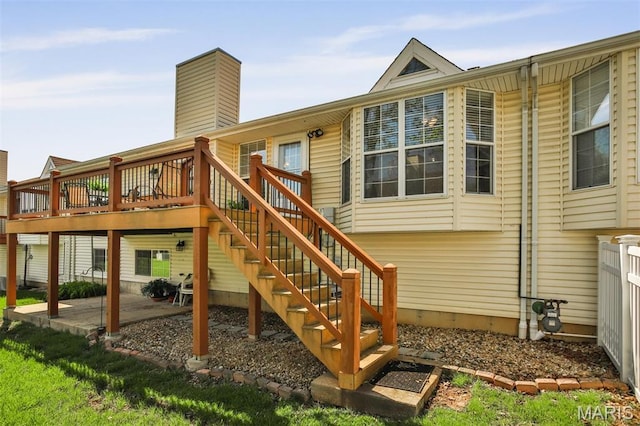 2015 Chapel Hill Xing, Saint Peters, MO 63376 - back of property with a deck, a patio area, a chimney, and stairs