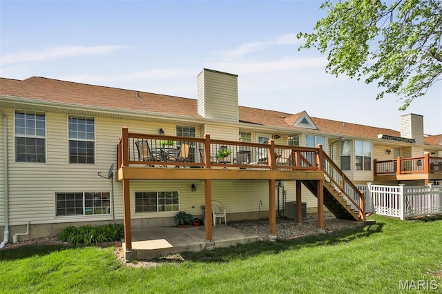 2015 Chapel Hill Xing, Saint Peters, MO 63376 - rear view of house with a patio, a lawn, a deck, a chimney, and stairs
