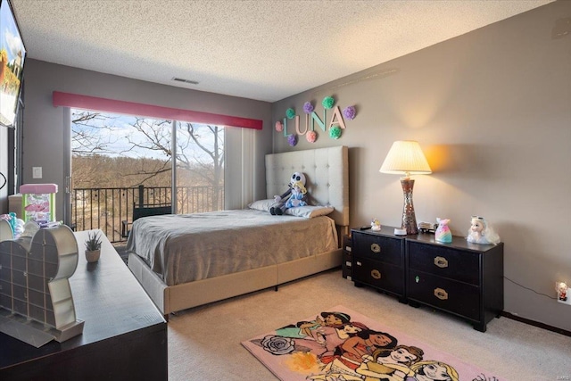 bedroom with light colored carpet, access to outside, and a textured ceiling