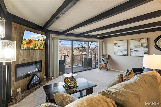 92 Waters Edge Ct Unit 15-2B, Four Seasons, MO 65049 - living room with a large fireplace, carpet flooring, beam ceiling, wood walls, and baseboards