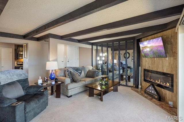 92 Waters Edge Ct Unit 15-2B, Four Seasons, MO 65049 - carpeted living room featuring beam ceiling, a glass covered fireplace, a textured ceiling, and wood walls