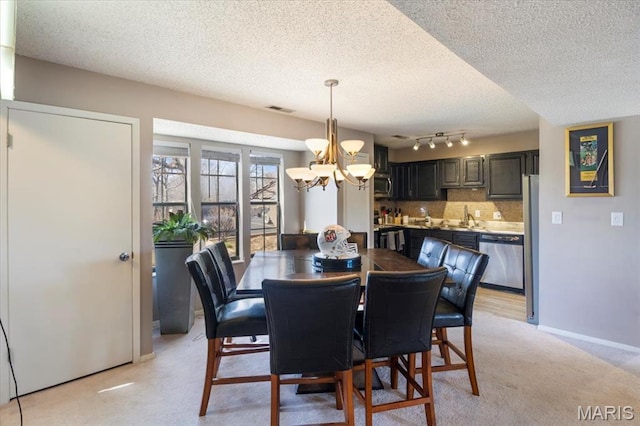 92 Waters Edge Ct Unit 15-2B, Four Seasons, MO 65049 - dining area featuring a chandelier, a textured ceiling, and light carpet