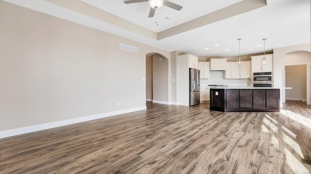 149 Haven Ridge Ct, Dardenne Prairie, MO 63368 - kitchen with arched walkways, stainless steel appliances, open floor plan, light countertops, and recessed lighting