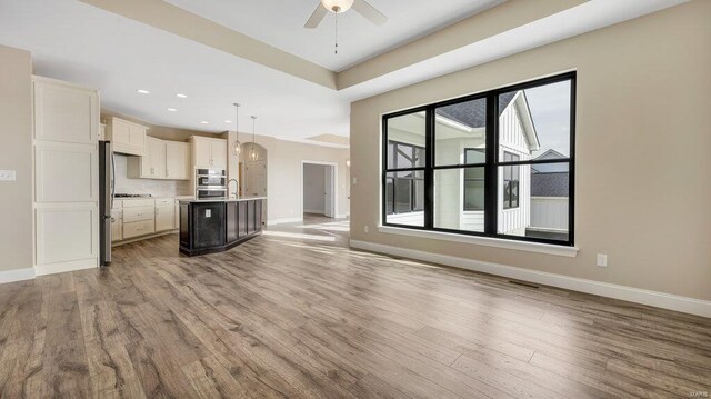 149 Haven Ridge Ct, Dardenne Prairie, MO 63368 - unfurnished living room with baseboards, light wood-style flooring, ceiling fan, and recessed lighting