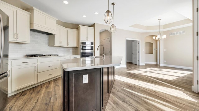 149 Haven Ridge Ct, Dardenne Prairie, MO 63368 - kitchen featuring arched walkways, appliances with stainless steel finishes, baseboards, light countertops, and recessed lighting
