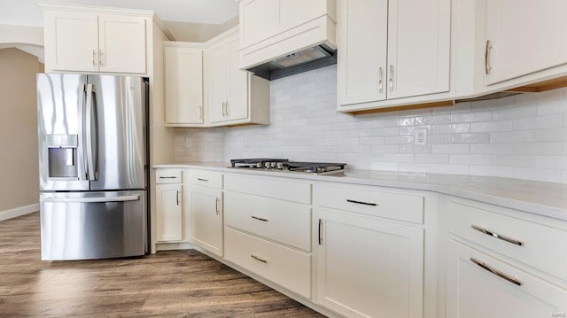 149 Haven Ridge Ct, Dardenne Prairie, MO 63368 - kitchen featuring appliances with stainless steel finishes, dark wood-style floors, white cabinetry, tasteful backsplash, and premium range hood