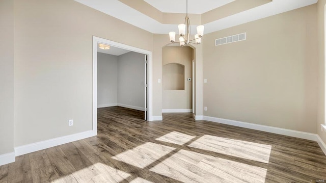 149 Haven Ridge Ct, Dardenne Prairie, MO 63368 - unfurnished room with wood finished floors, arched walkways, and baseboards
