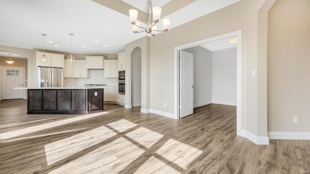 149 Haven Ridge Ct, Dardenne Prairie, MO 63368 - kitchen featuring stainless steel appliances, light countertops, light wood-style floors, decorative backsplash, and recessed lighting