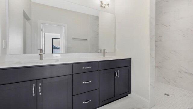 149 Haven Ridge Ct, Dardenne Prairie, MO 63368 - bathroom with marble look tile flooring, double vanity, baseboards, and a tile shower